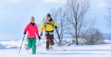 Two snowshoers running in deep snow