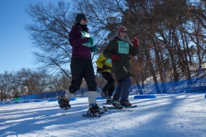 Abbey Engebretson, St Paul (11) runs the snowshoe road with Greg Schultz and Annemarie Peterson