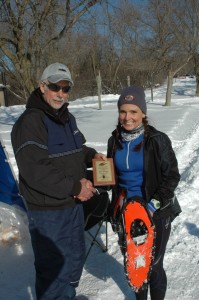 Ottilie Walls proudly displays her Northern Lites Snowshoes that aided her 20 km women's title.